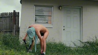 twink trimming the grass naked outside