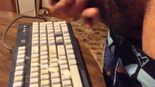 Masturbating until I shoot my load on a computer keyboard