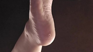 Bored goth girl ignores you under her desk dangling feet and flipping you off