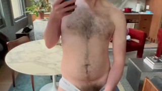 BUSHY UNCUT OTTER JERKS OFF IN MIRROR