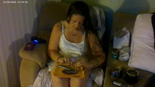 Busty girl in pink bra and panties smoking and playing video games