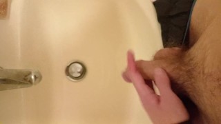 Piss in the sink from my long, floppy, hairy cut cock with balls out