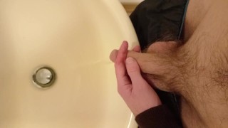 Piss in the sink from my long, floppy, hairy cut cock with balls out