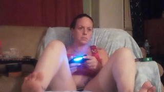 Pretty girl smoking cigarette and playing video games, while I film up her mini dress