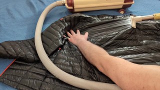 Vacuuming Dark Shark Ghost Whisperer Down Jacket with Vintage Electrolux Vacuum Cleaner