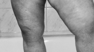 Chubby MILF shaves her pussy in the shower - black and white