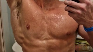Very hot boy enjoys the power of the shower