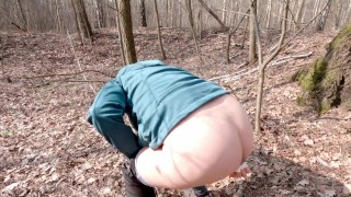 Early spring on bike pissing in the forest near the busy road