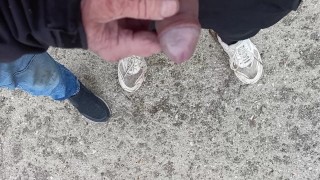 Friend is holding my cock while im peeing on the ground outdoor