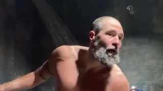 Bearded muscular jock pisses in gym locker room shower