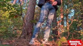 Guy long pissing in the forest under a tree