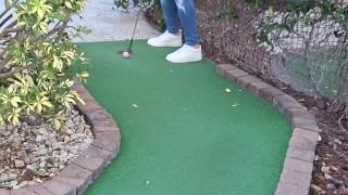 Small petite girl playing golf and not doing good at it