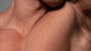 Fitness model licking his own biceps