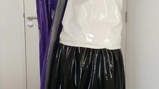 Putting on latex saint priest robe coat gown over schoolgirl sailor uniform and rubber skirt layers