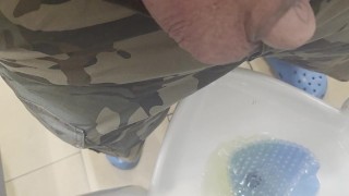 Peeing in public restroom.  Yes, the heart is tattooed.